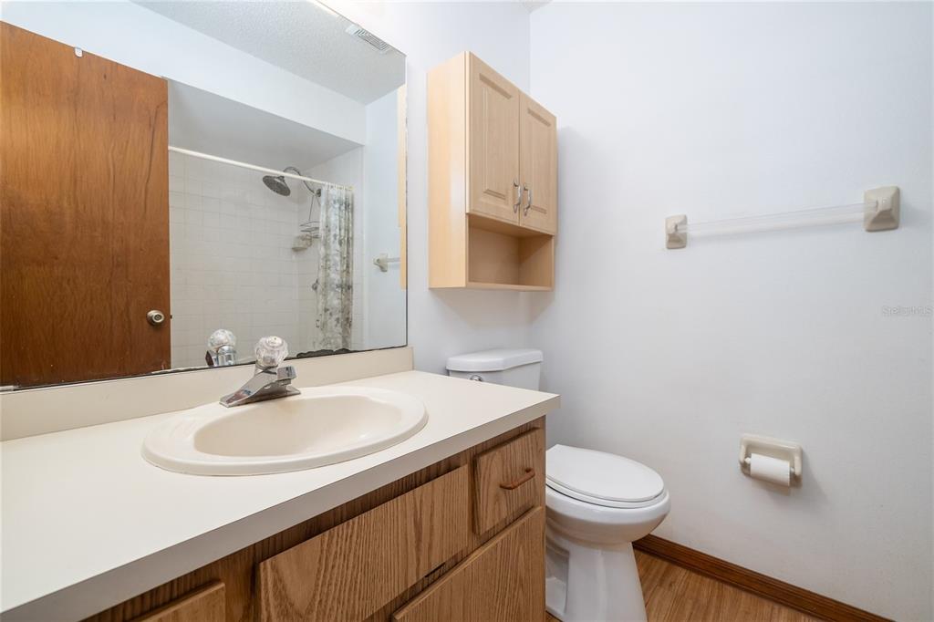 3221 Lime Tree Drive Edgewater, FL 32141 - Photo 17 of 29 a bathroom with a sink a toilet and a mirror