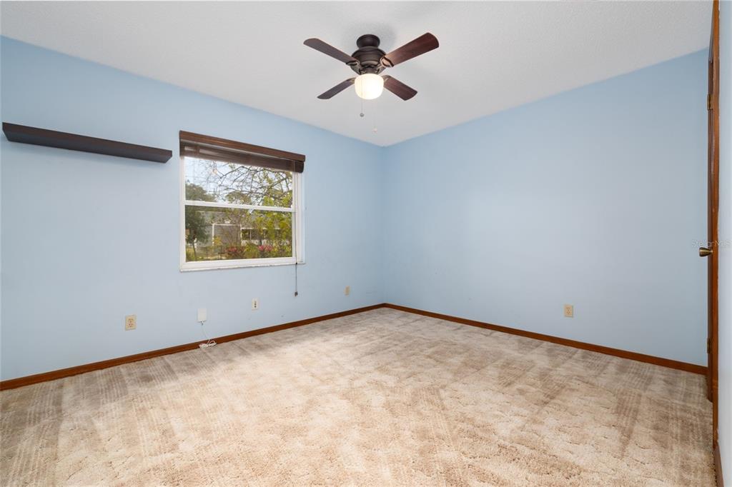 3221 Lime Tree Drive Edgewater, FL 32141 - Photo 20 of 28 an empty room with ceiling fan and window