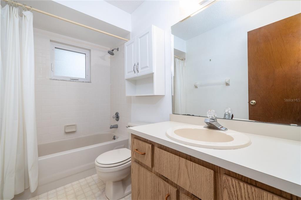 3221 Lime Tree Drive Edgewater, FL 32141 - Photo 21 of 28 a bathroom with a sink a toilet and shower