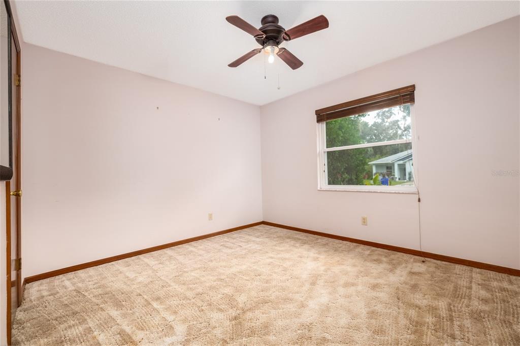 3221 Lime Tree Drive Edgewater, FL 32141 - Photo 22 of 28 an empty room with a window and a ceiling fan