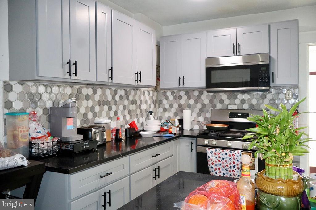 3420 Penn Avenue Sinking Spring, PA 19608 - Photo 3 of 34 a kitchen with stainless steel appliances a stove a sink and a microwave