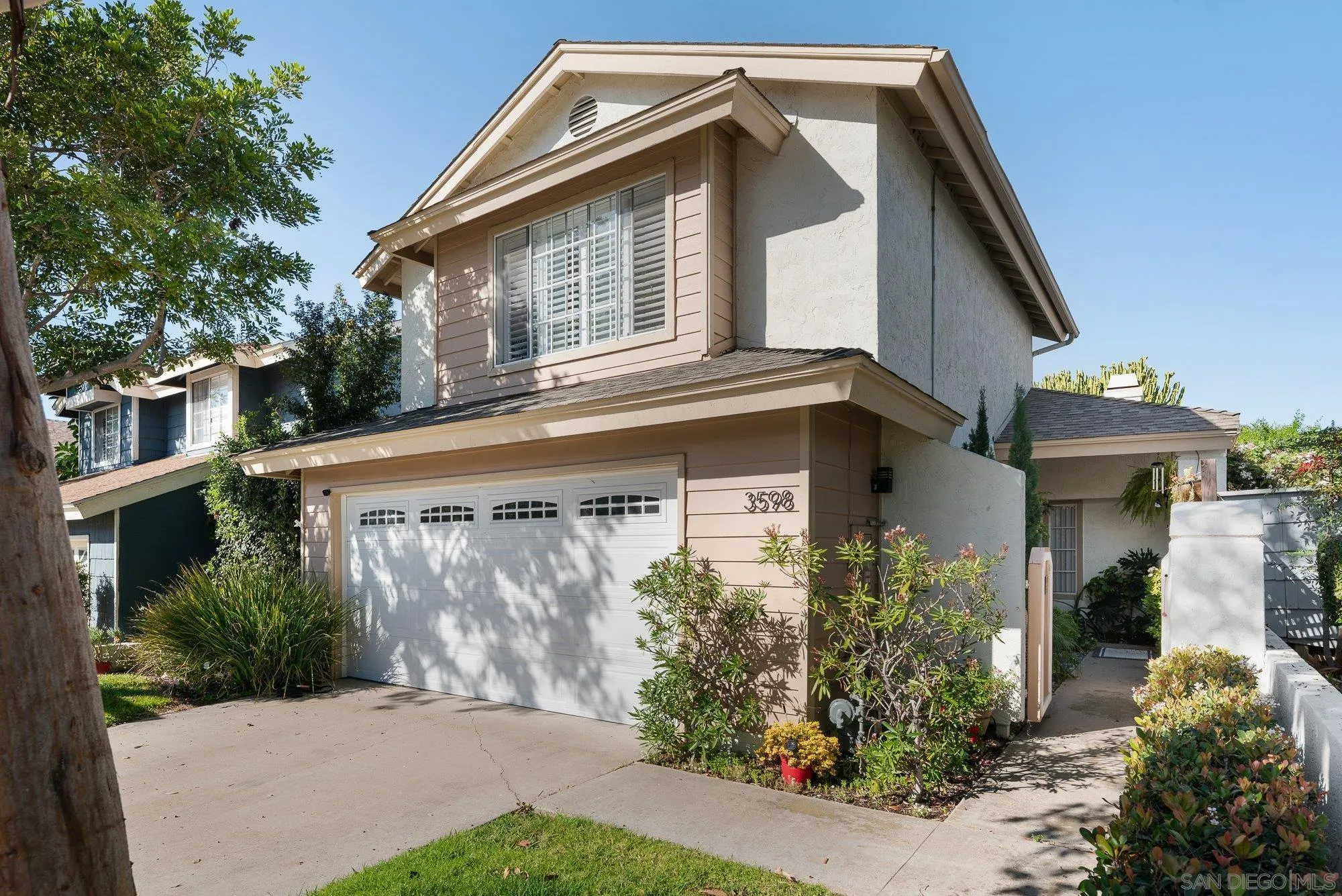 a front view of a house with garden