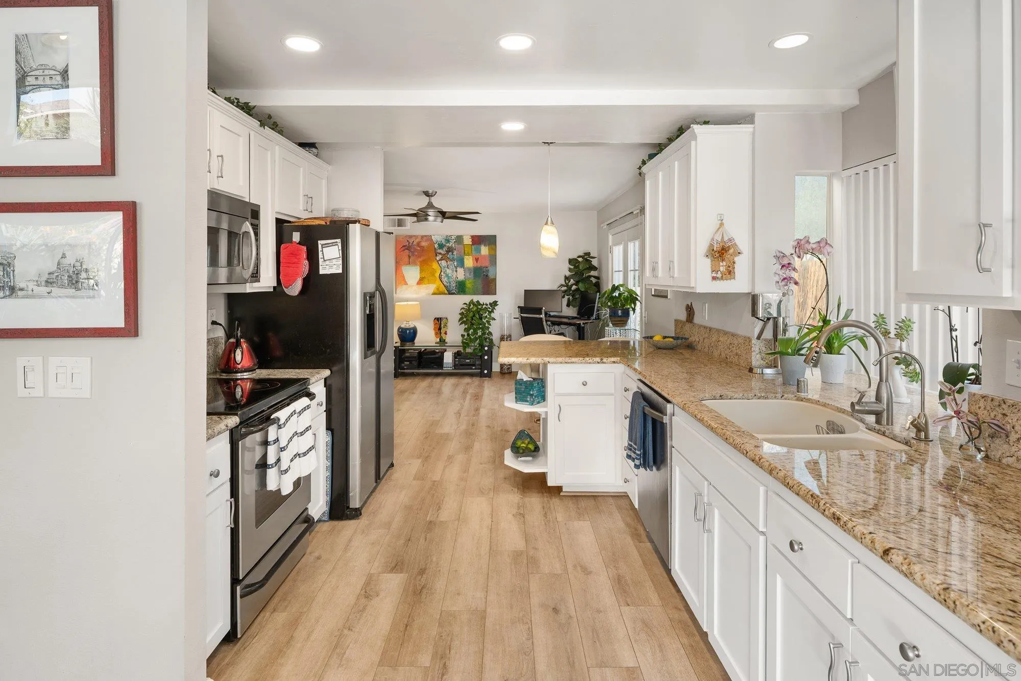 3598 Old Cobble Road San Diego, CA 92111 - Photo 15 of 42 a kitchen with stainless steel appliances granite countertop lots of counter top space and wooden floor