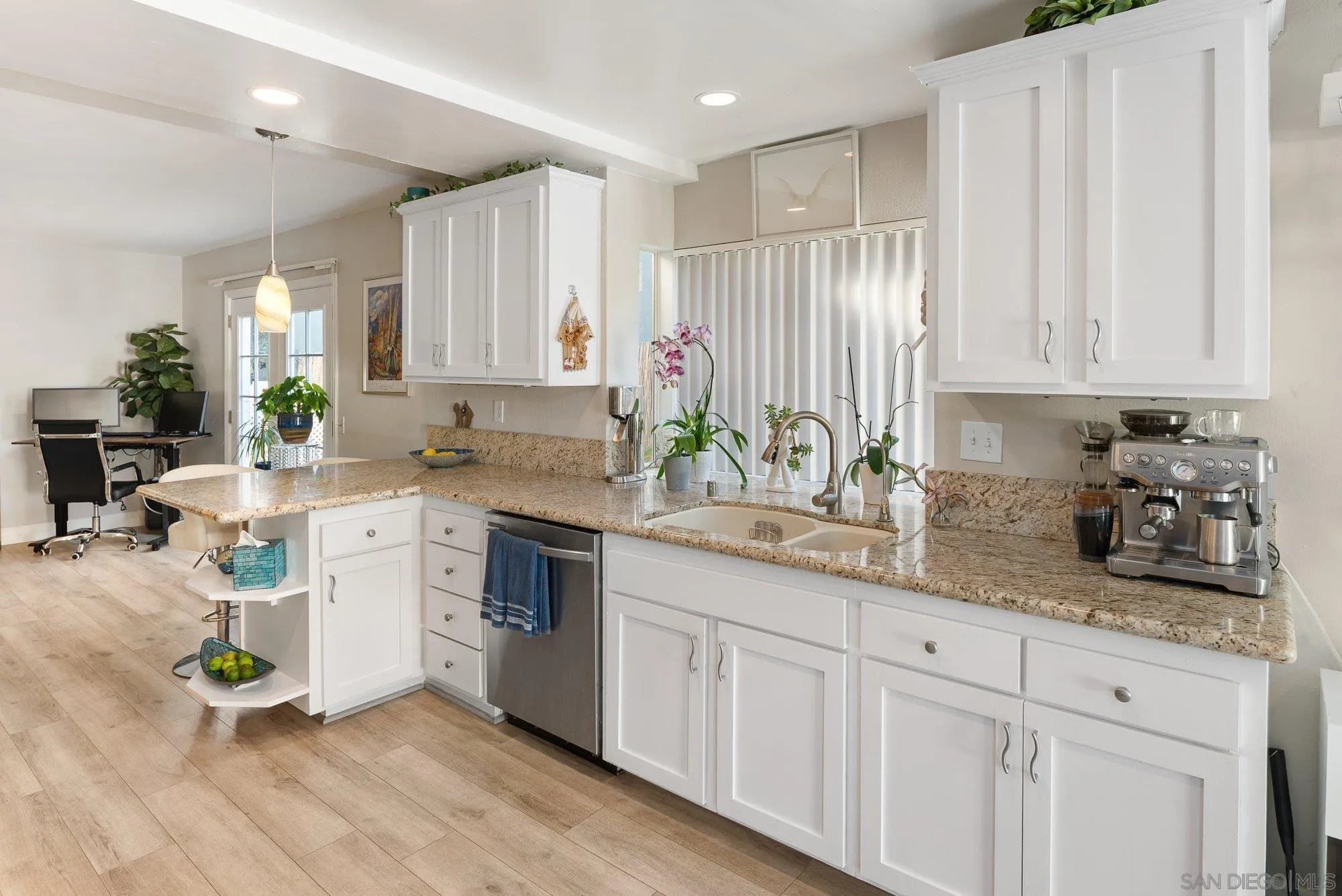 3598 Old Cobble Road San Diego, CA 92111 - Photo 16 of 42 a kitchen with stainless steel appliances granite countertop white cabinets a sink and dishwasher with wooden floor