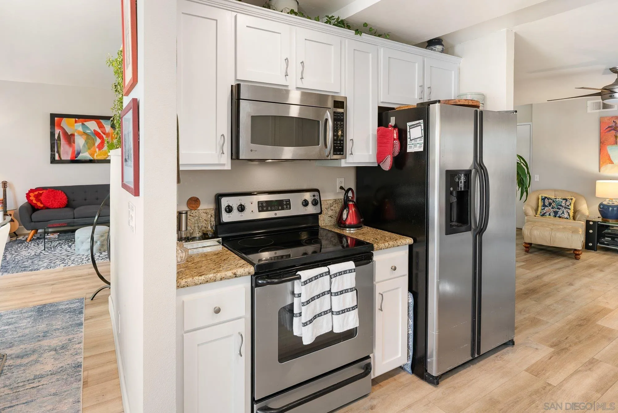 3598 Old Cobble Road San Diego, CA 92111 - Photo 17 of 42 a kitchen with stainless steel appliances granite countertop a refrigerator stove and microwave