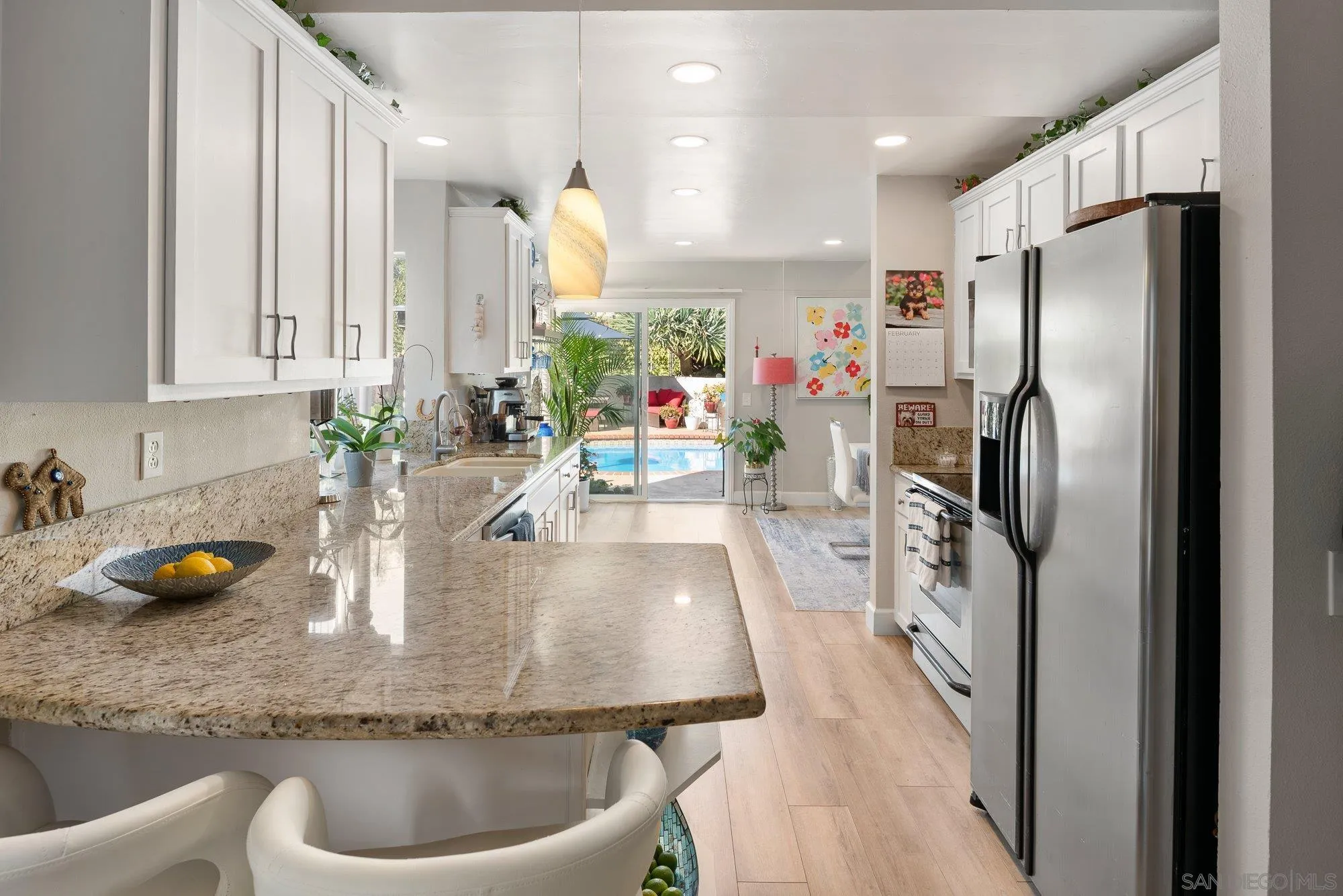 3598 Old Cobble Road San Diego, CA 92111 - Photo 19 of 42 a kitchen with a sink and refrigerator