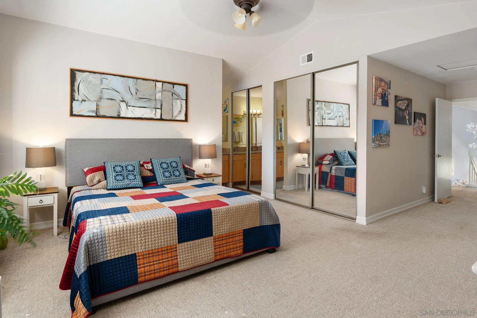 3598 Old Cobble Road San Diego, CA 92111 - Photo 26 of 42 a bedroom with a bed a table and painting