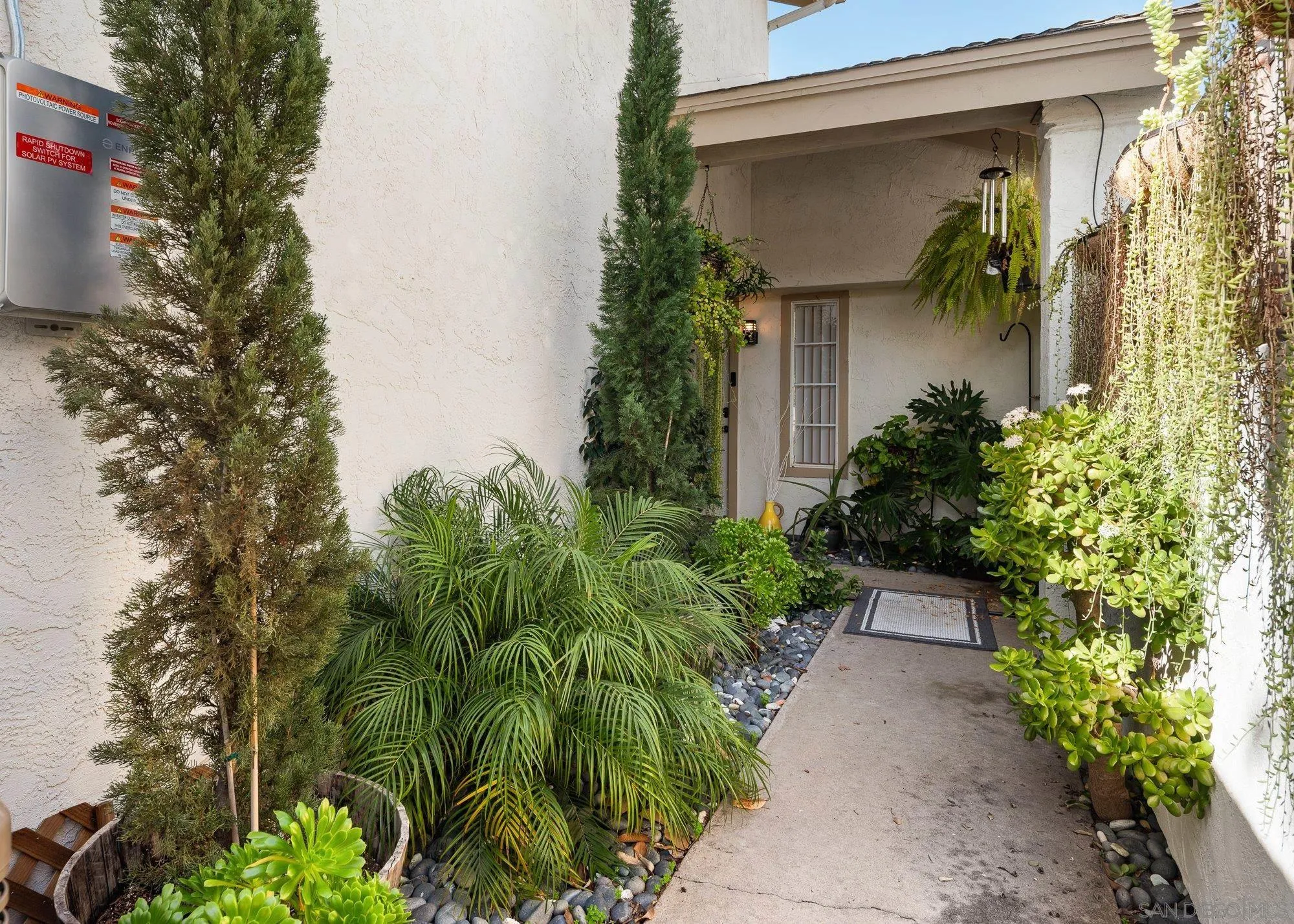 3598 Old Cobble Road San Diego, CA 92111 - Photo 3 of 42 a front view of a house with a yard