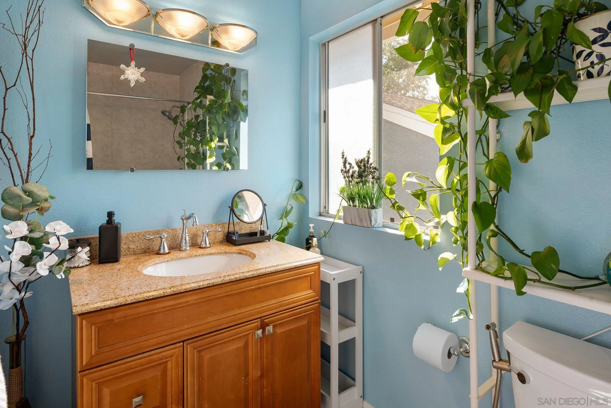 3598 Old Cobble Road San Diego, CA 92111 - Photo 32 of 42 a bathroom with a granite countertop sink a toilet and a mirror