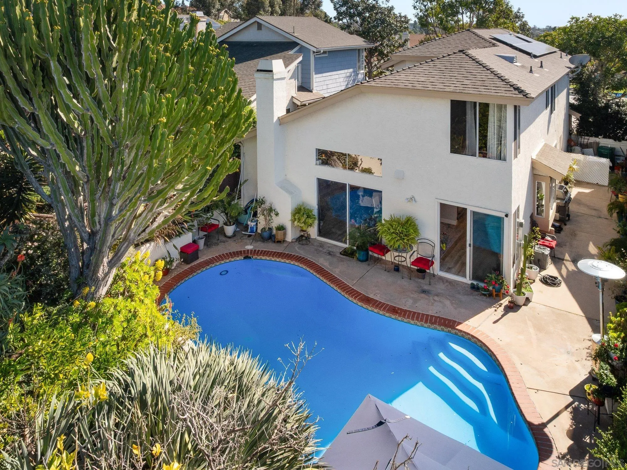 3598 Old Cobble Road San Diego, CA 92111 - Photo 38 of 42 a view of swimming pool with outdoor seating and house in the background
