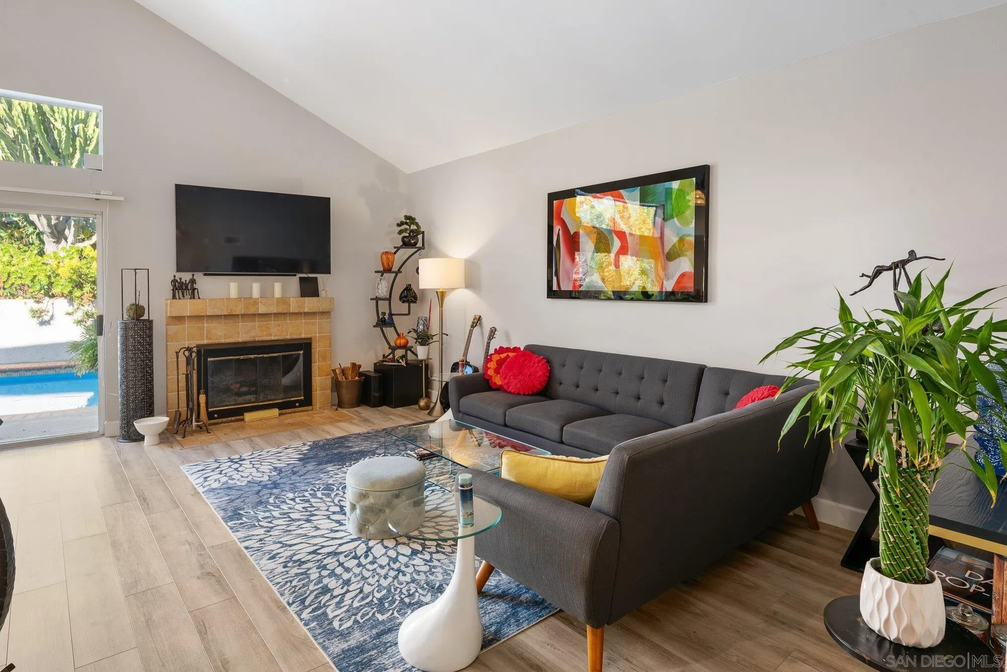 3598 Old Cobble Road San Diego, CA 92111 - Photo 6 of 42 a living room with furniture potted plant and a flat screen tv