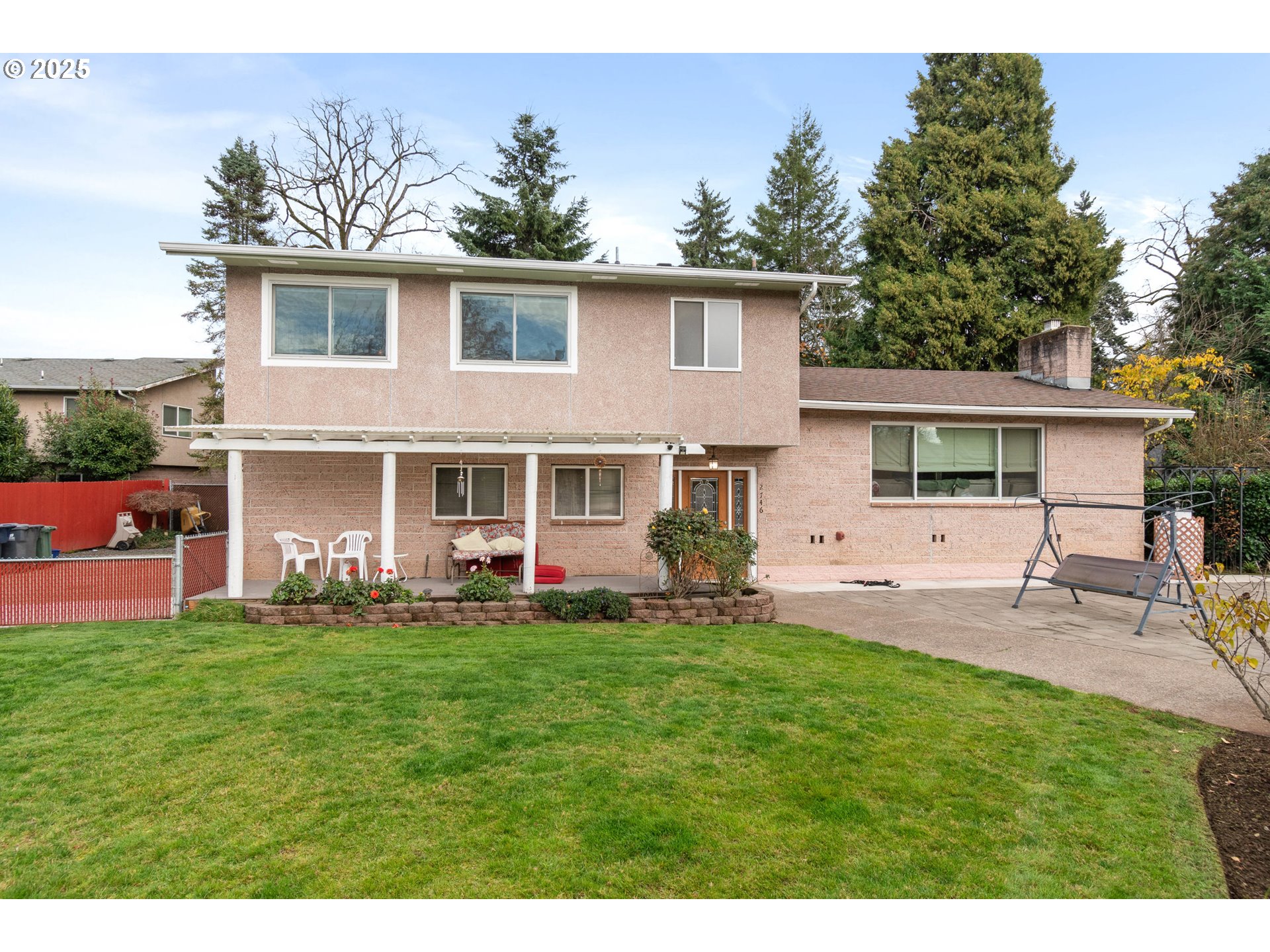 2746 Harlow Road Eugene, OR 97401 - Photo 1 of 22 a front view of a house with a garden and patio