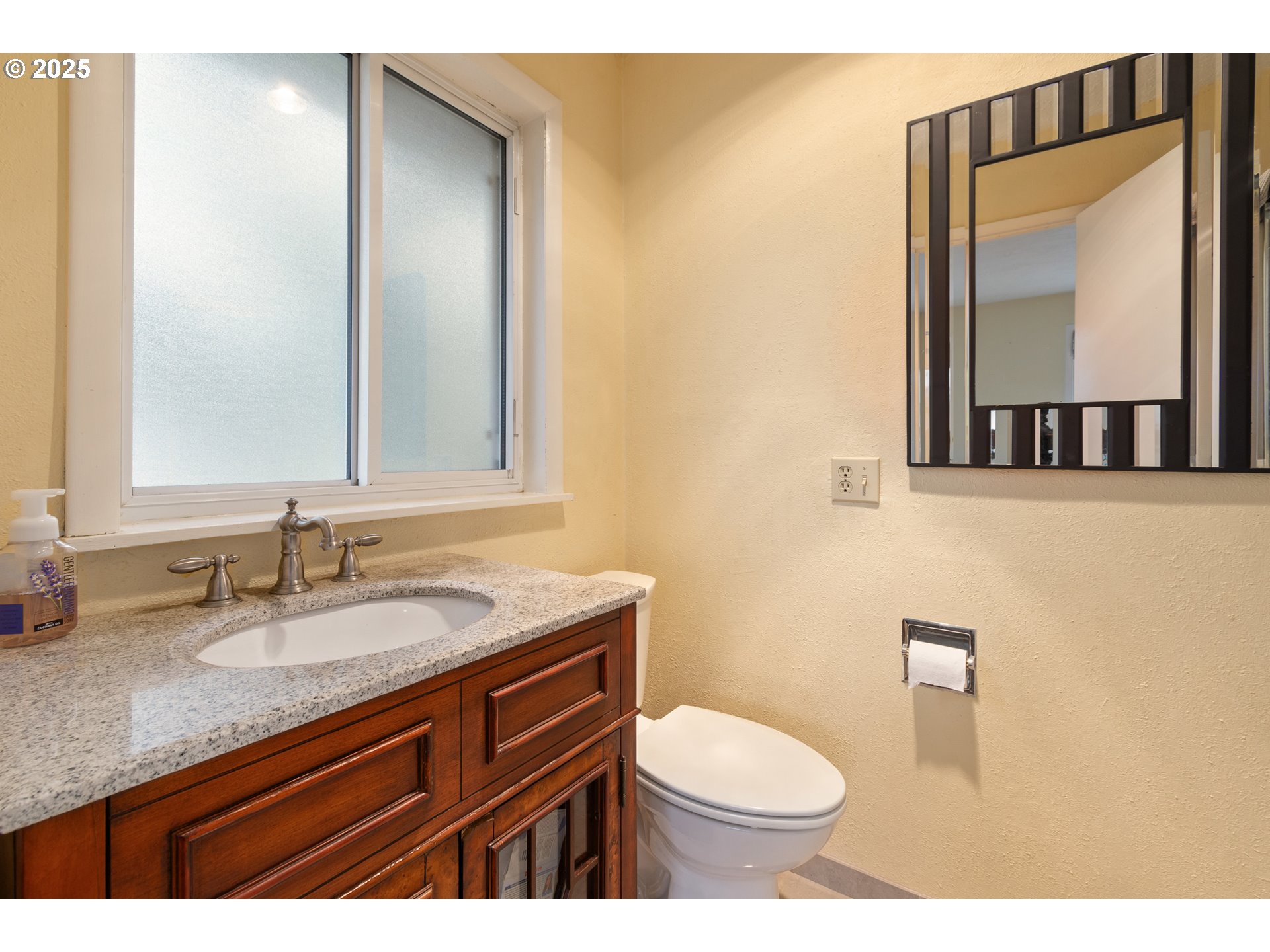2746 Harlow Road Eugene, OR 97401 - Photo 18 of 22 a bathroom with a granite countertop toilet sink and mirror