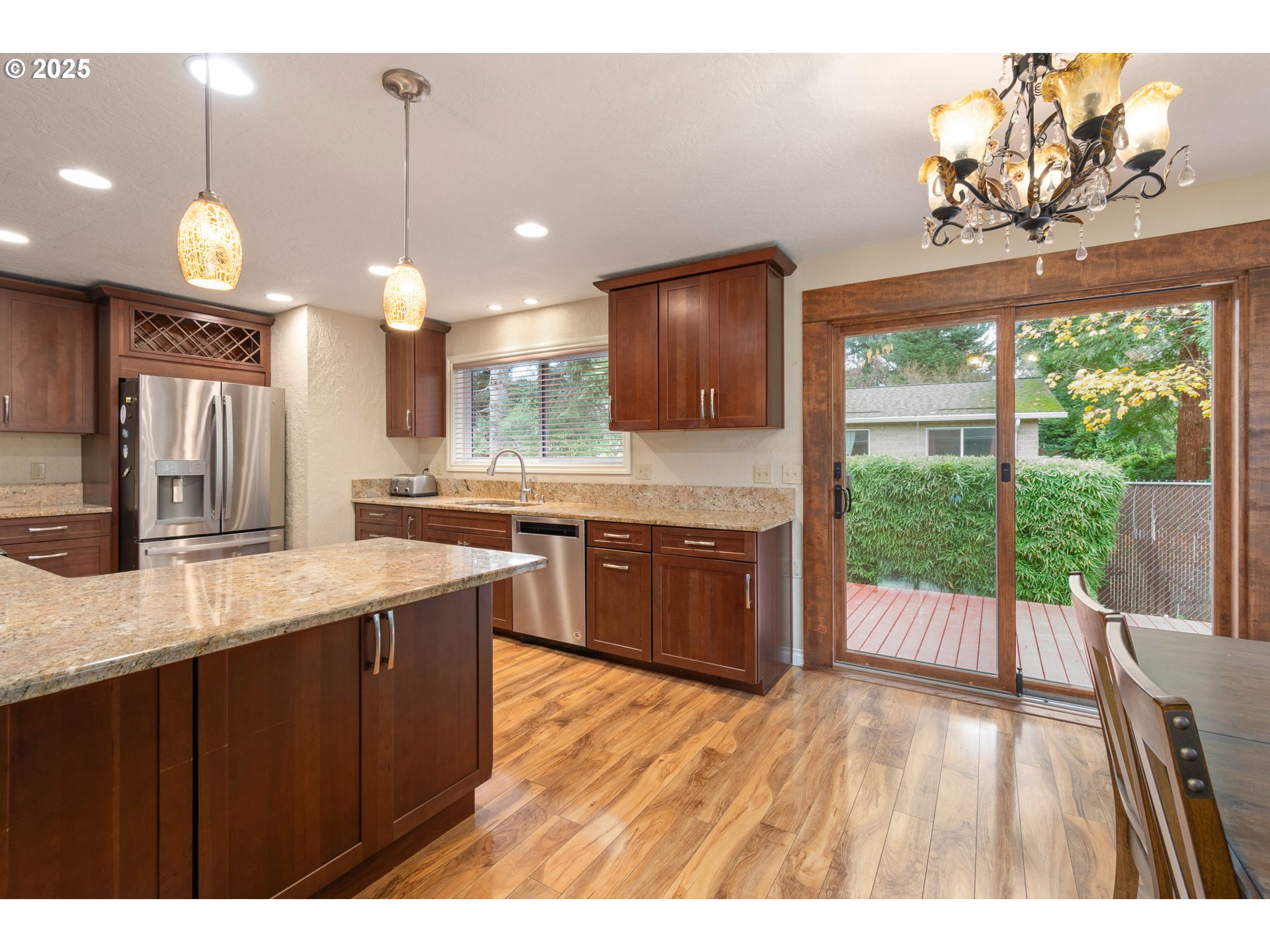 2746 Harlow Road Eugene, OR 97401 - Photo 7 of 22 a large kitchen with kitchen island a large island in the center and stainless steel appliances