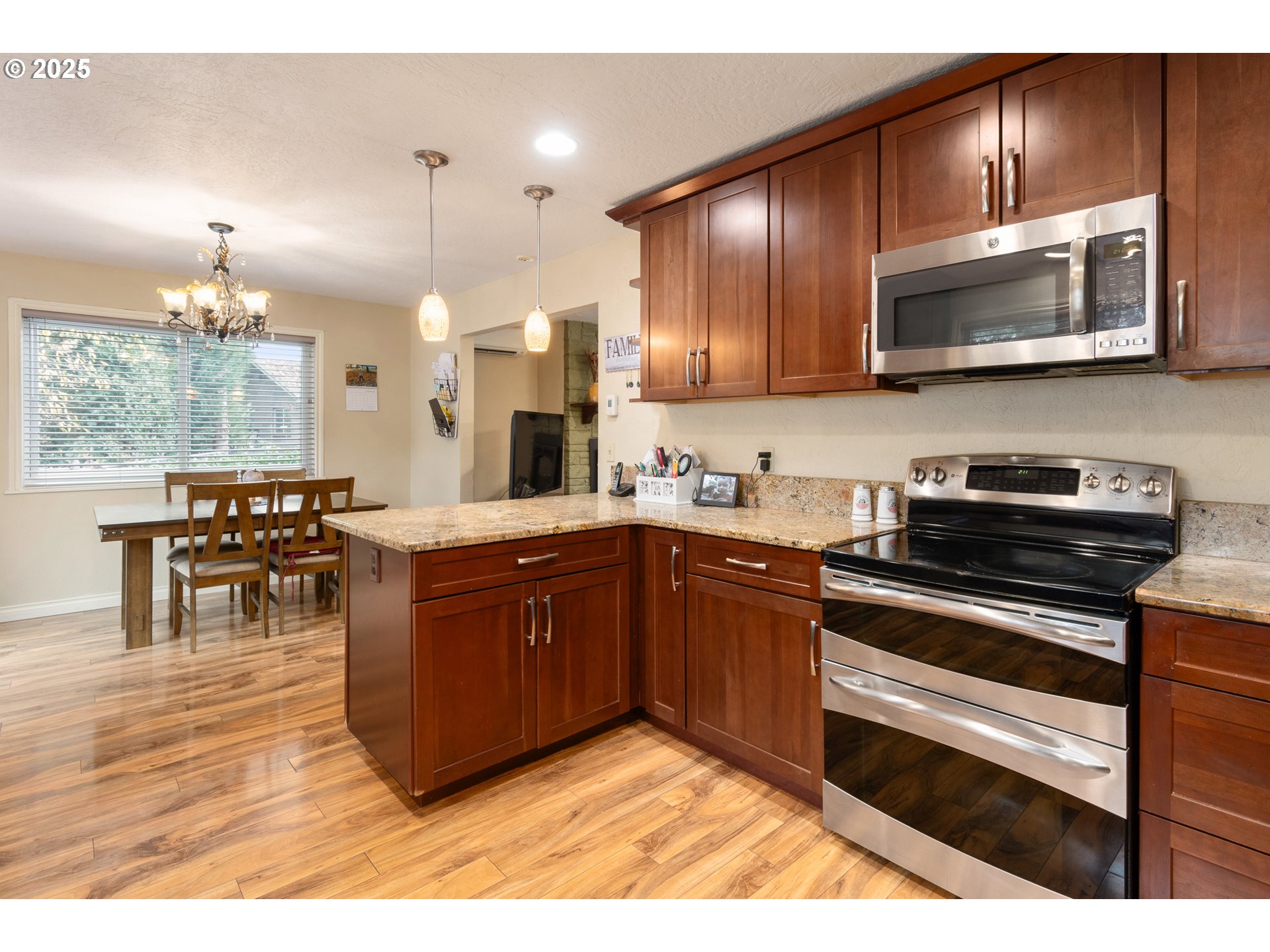 2746 Harlow Road Eugene, OR 97401 - Photo 10 of 22 a kitchen with stainless steel appliances granite countertop wooden cabinets a stove a sink and a microwave