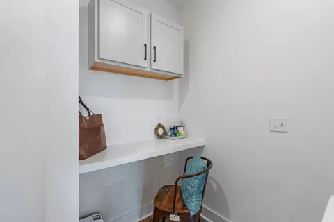 a view of cabinets with wooden floor and chair