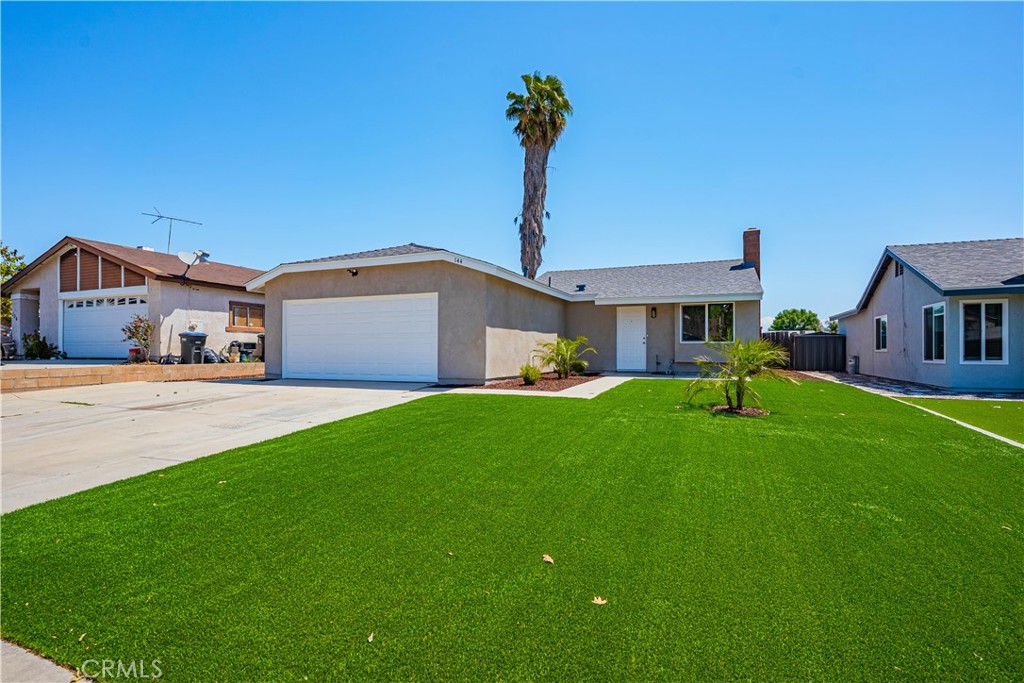144 South Ralph Road Lake Elsinore, CA 92530 - Photo 1 of 1 a front view of a house with a yard and trees