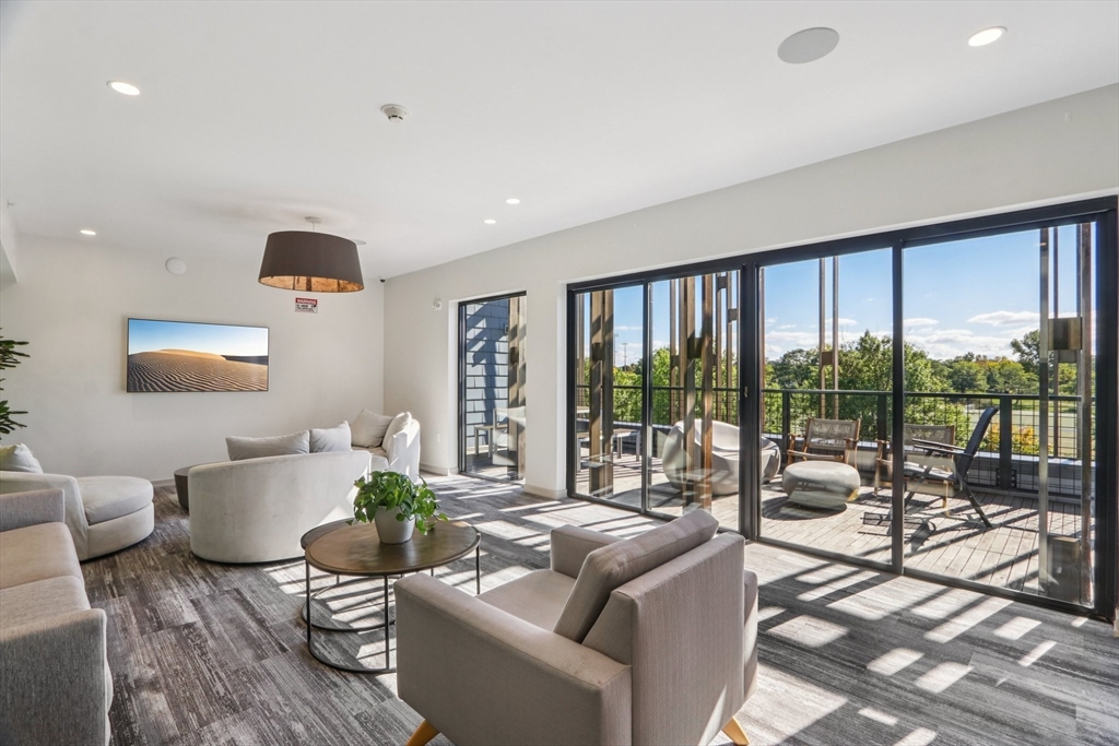 77 New Street, Unit 214 Cambridge, MA 02138 - Photo 12 of 25 a living room with furniture and a large window