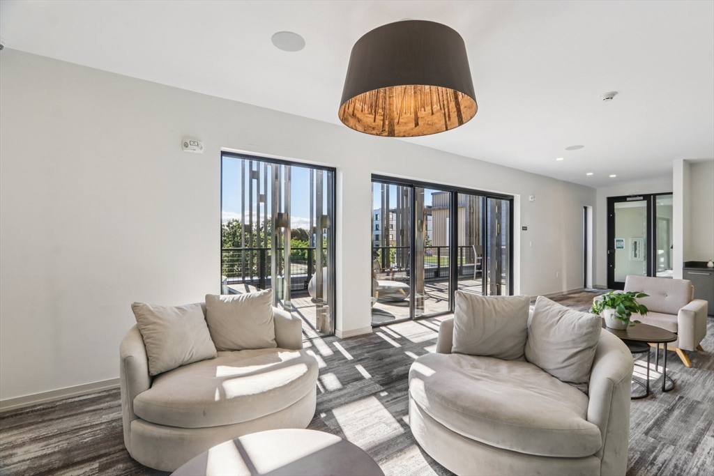 77 New Street, Unit 214 Cambridge, MA 02138 - Photo 13 of 25 a living room with furniture and a large window