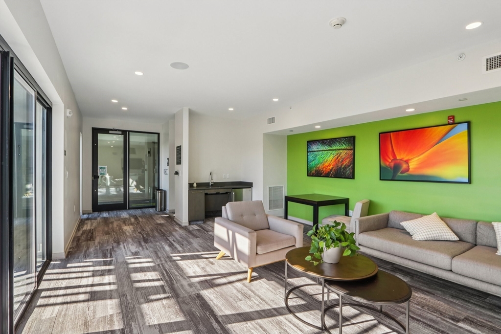 77 New Street, Unit 214 Cambridge, MA 02138 - Photo 14 of 25 a living room with furniture a rug and a flat screen tv