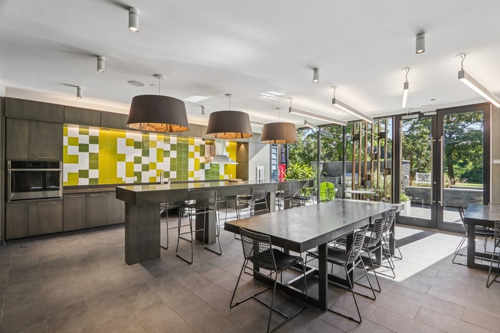 77 New Street, Unit 214 Cambridge, MA 02138 - Photo 18 of 25 a view of a dining room with furniture window and outdoor kitchen