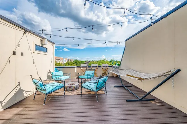 a view of a chairs and table in patio with wooden floor
