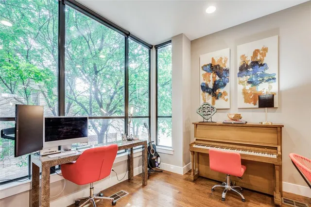 a view of a workspace with furniture and a window