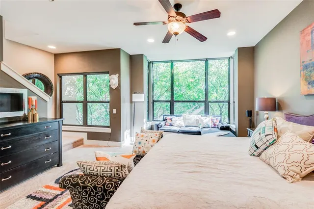 a bedroom with a large bed and a window