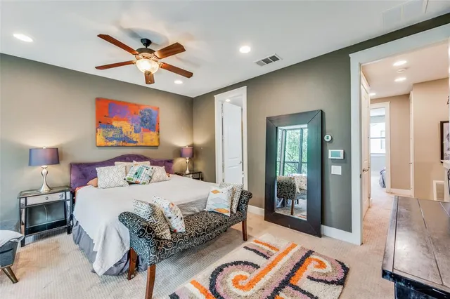 a bedroom with a bed and glass walk in closet