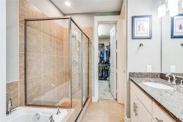 a bathroom with a granite countertop sink a mirror and shower