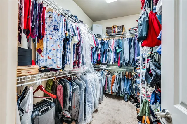a view of walk in closet with clothes