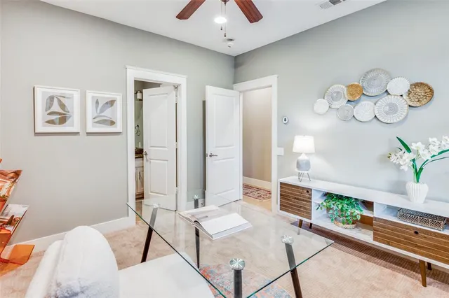 a living room with furniture and a potted plant