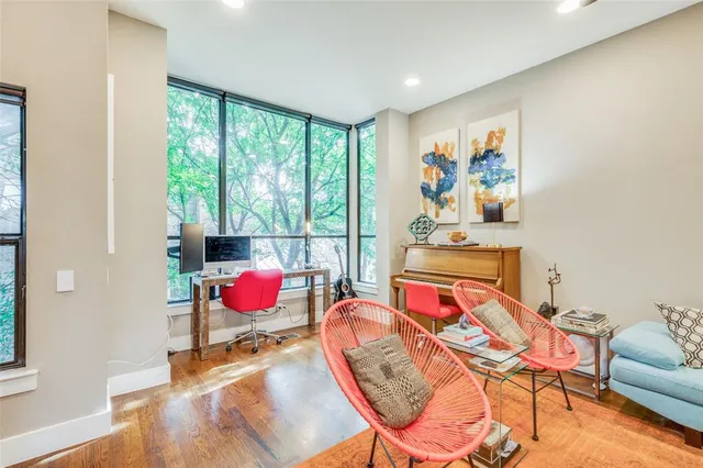 a living room with furniture and a floor to ceiling window