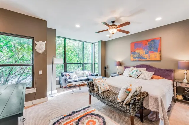 a bedroom with a bed and a large window