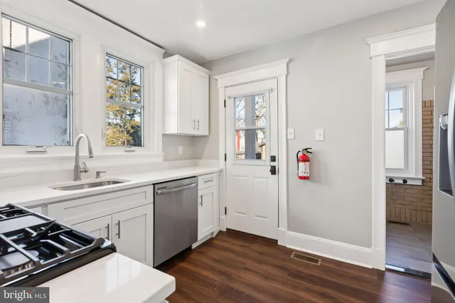 a kitchen that has a sink and a stove in it