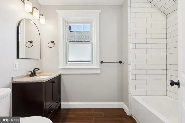a bathroom with a sink toilet and tub