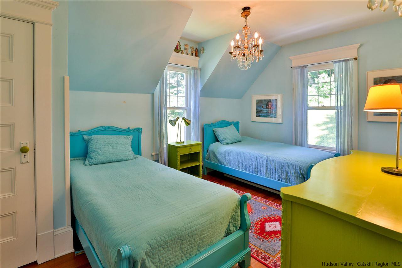455 Main Street Fleischmanns, NY 12430 - Photo 23 of 35 a bedroom with two beds and a chandelier