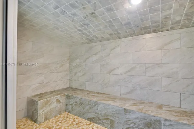 a living room with furniture pool table and chandelier
