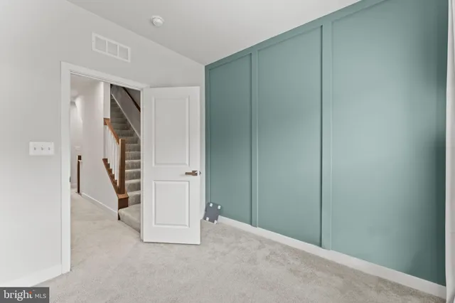 an empty room with an empty space and a refrigerator