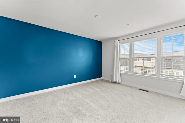 an empty room with a empty space and a window