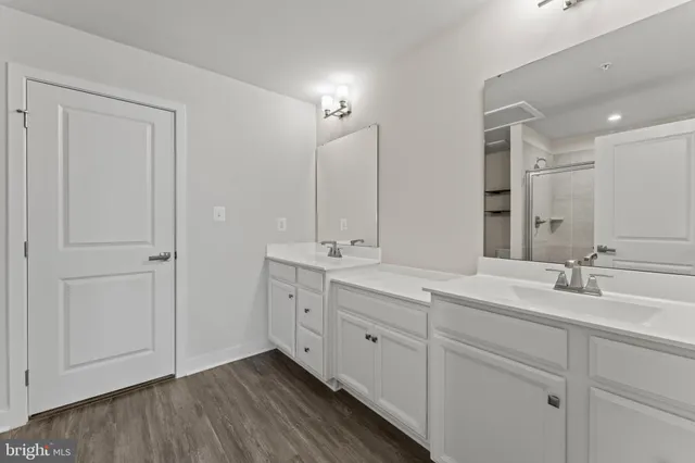 a bathroom with a double vanity sink and mirror