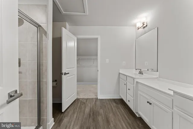 a spacious bathroom with a double vanity sink and a mirror