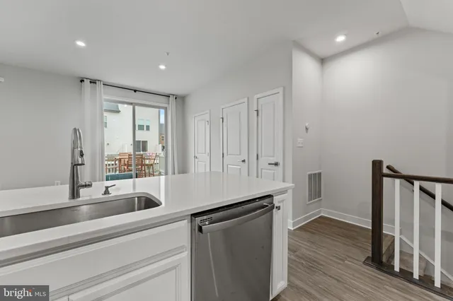a kitchen with a sink appliances and cabinets