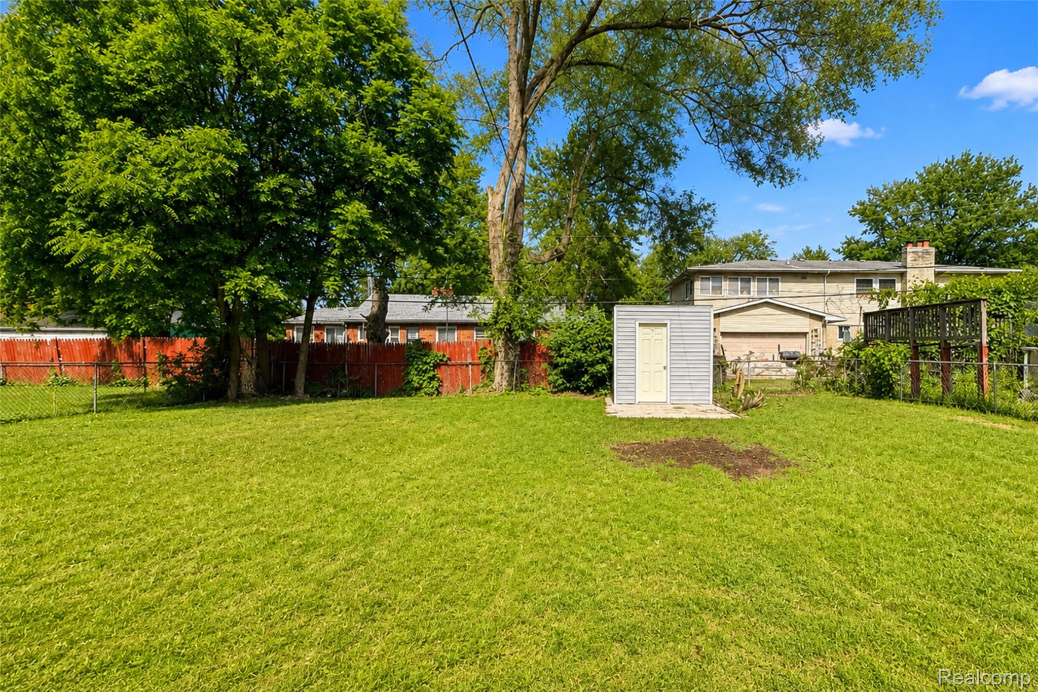 201 Cardwell Street Inkster, MI 48141 - Photo 9 of 41 Expansive green lawn featuring mature trees and a detached storage shed