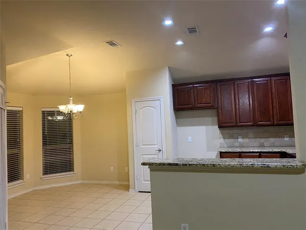 a kitchen with granite countertop a stove a sink and a microwave