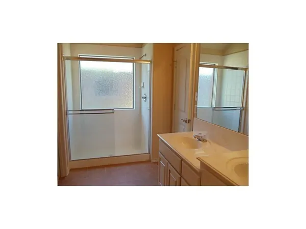 a bathroom with a sink vanity and a mirror