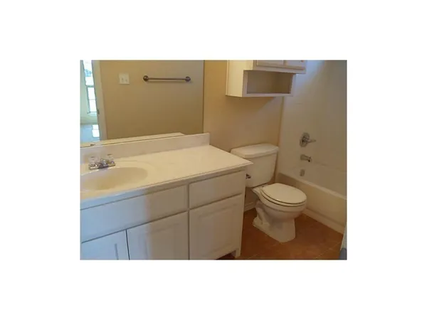 a bathroom with a sink a toilet and vanity