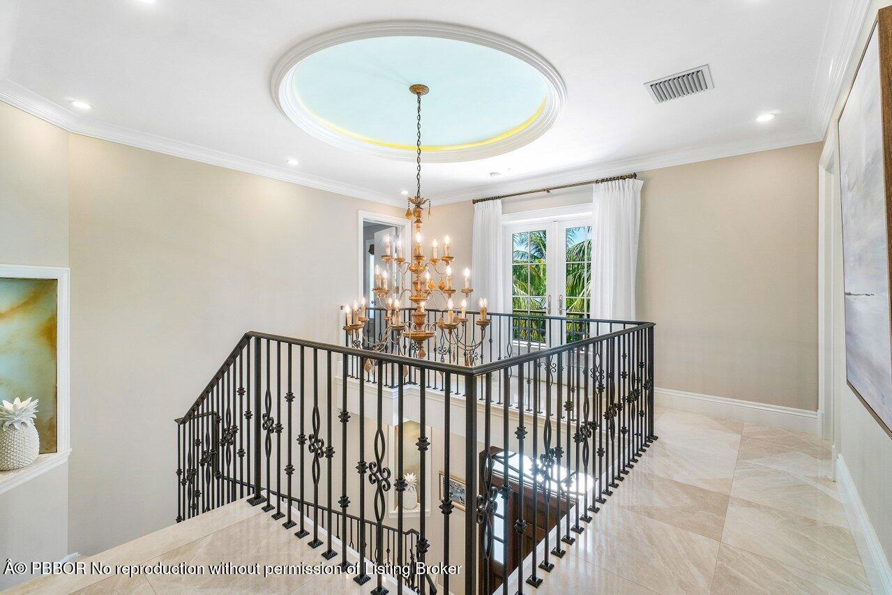 134 Seagate Road Palm Beach, FL 33480 - Photo 12 of 29 a view of a hallway with a chandelier