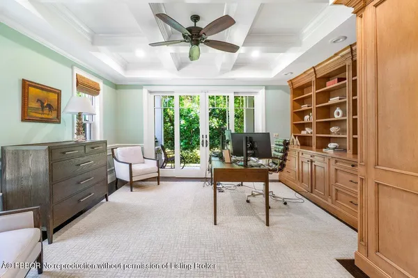 a view of a livingroom with workspace and a window