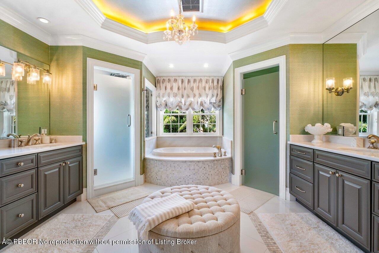 134 Seagate Road Palm Beach, FL 33480 - Photo 19 of 29 a spacious bathroom with a sink a large mirror and a bathtub